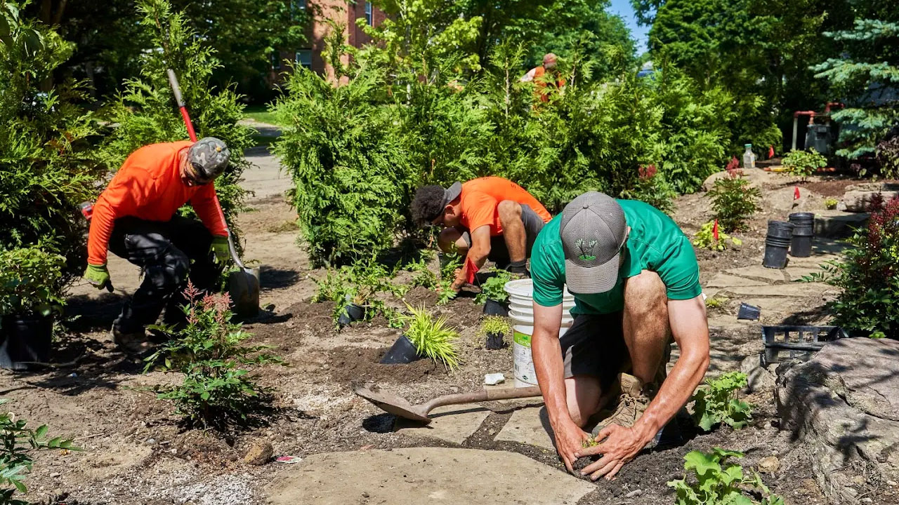 Crew hand-planting a new bed on a Cleveland property